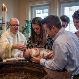 Father Boyle performing a Baptism